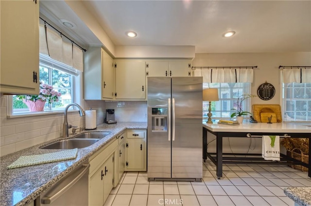 430 N Canyon Blvd, Monrovia, CA 91016 - kitchen with appliances with stainless steel finishes, tasteful backsplash, light tile patterned floors, and light stone counters