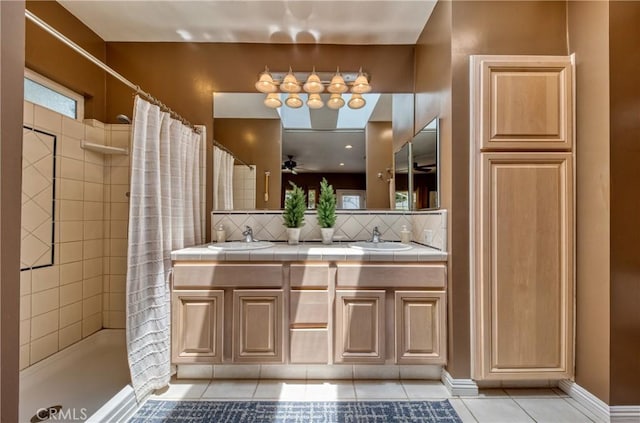 430 N Canyon Blvd, Monrovia, CA 91016 - bathroom featuring tile patterned floors, a tile shower, tasteful backsplash, and double vanity