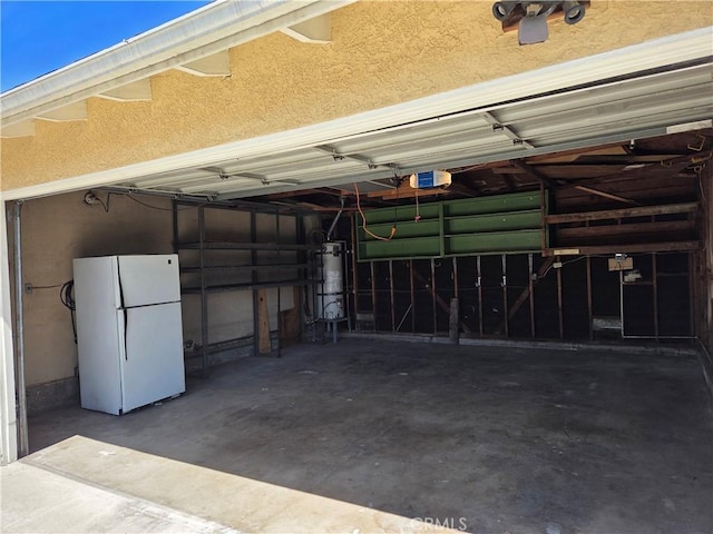 11505 Elmhurst Dr, Norwalk, CA 90650 - garage featuring freestanding refrigerator, water heater, and a garage door opener