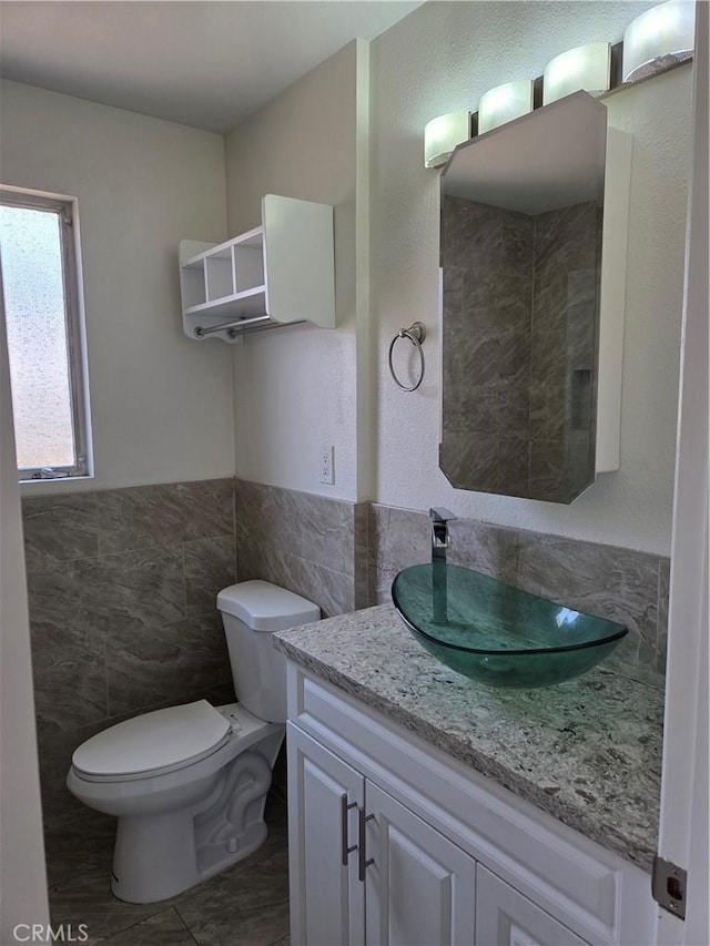 11505 Elmhurst Dr, Norwalk, CA 90650 - bathroom featuring tile walls, vanity, and wainscoting
