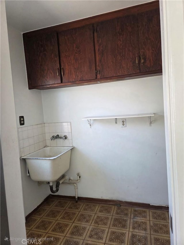 11505 Elmhurst Dr, Norwalk, CA 90650 - laundry area with cabinet space, pet washing area, and dark flooring