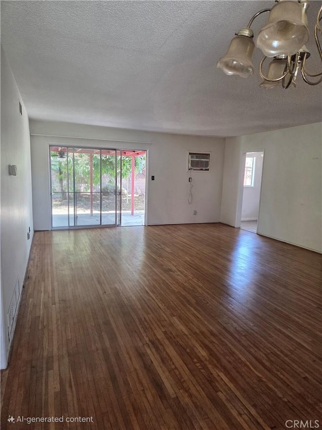 11505 Elmhurst Dr, Norwalk, CA 90650 - unfurnished living room featuring wood finished floors, a chandelier, an AC wall unit, and a textured ceiling