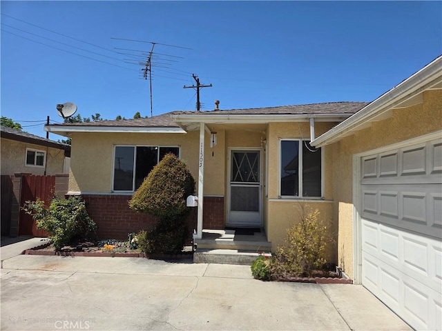 11505 Elmhurst Dr, Norwalk, CA 90650 - view of front facade with stucco siding, a garage, and brick siding