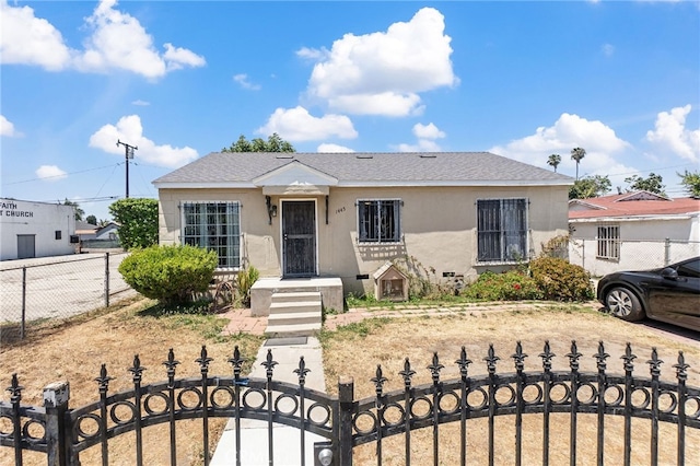 1445 W 155th St, Compton, CA 90220 - bungalow with a fenced front yard, stucco siding, and a shingled roof