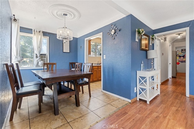 1445 W 155th St, Compton, CA 90220 - dining space featuring a textured wall, a chandelier, and light wood finished floors