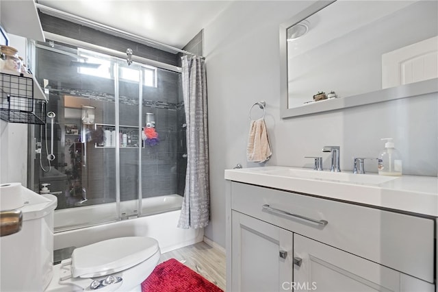 1445 W 155th St, Compton, CA 90220 - full bathroom featuring vanity, bath / shower combo with glass door, and wood finished floors