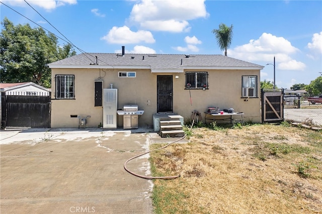 1445 W 155th St, Compton, CA 90220 - view of front facade with stucco siding, a gate, and a shingled roof