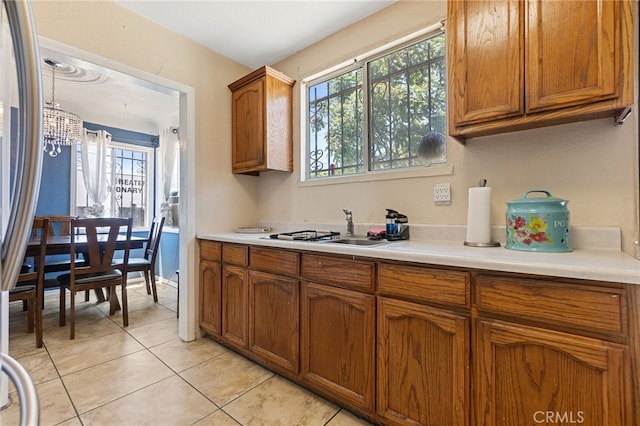 1445 W 155th St, Compton, CA 90220 - kitchen with brown cabinets, light countertops, and plenty of natural light