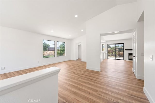 18085 Golden Leaf Ln, Riverside, CA 92504 - unfurnished living room with vaulted ceiling, light wood finished floors, recessed lighting, and a fireplace