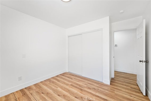 18085 Golden Leaf Ln, Riverside, CA 92504 - unfurnished bedroom with light wood-style floors and a closet