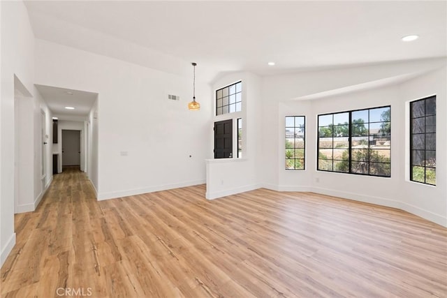18085 Golden Leaf Ln, Riverside, CA 92504 - unfurnished living room with light wood-type flooring, lofted ceiling, and recessed lighting