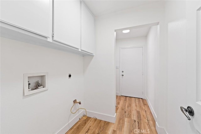 18085 Golden Leaf Ln, Riverside, CA 92504 - laundry room with cabinet space, hookup for a washing machine, and light wood-style flooring