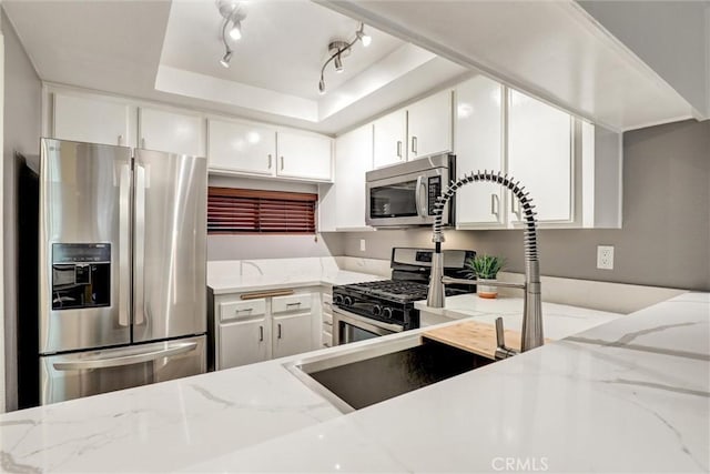 550 Orange Ave Unit 212, Long Beach, CA 90802 - kitchen featuring stainless steel appliances, white cabinetry, light stone counters, and a tray ceiling
