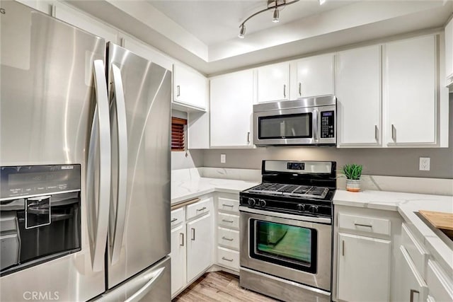 550 Orange Ave Unit 212, Long Beach, CA 90802 - kitchen featuring stainless steel appliances, white cabinets, and light wood finished floors