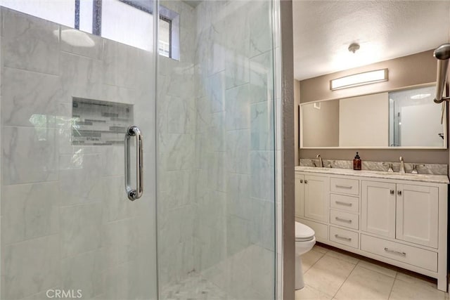550 Orange Ave Unit 212, Long Beach, CA 90802 - bathroom with a stall shower, double vanity, tile patterned flooring, and a textured ceiling