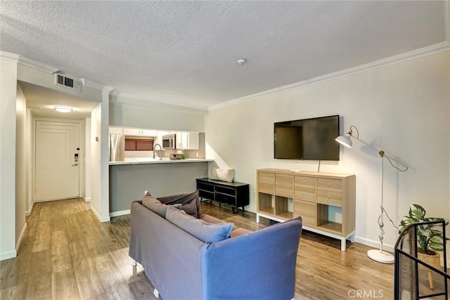 550 Orange Ave Unit 212, Long Beach, CA 90802 - living area featuring crown molding, light wood finished floors, and a textured ceiling