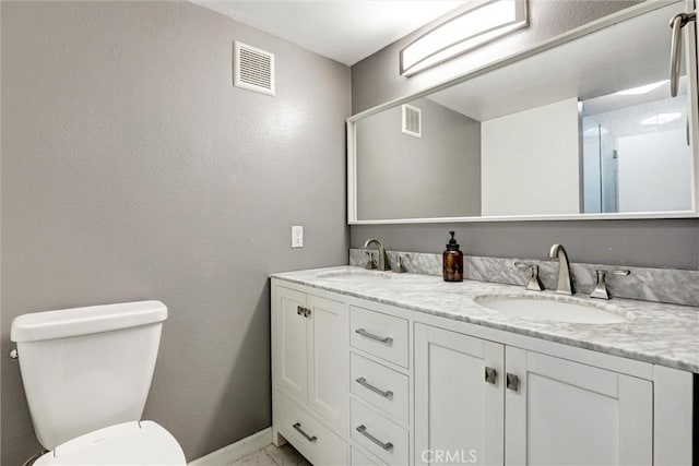550 Orange Ave Unit 212, Long Beach, CA 90802 - bathroom featuring double vanity, marble finish flooring, and a textured wall