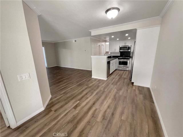 1564 Tanglewood Ln Unit 11, Escondido, CA 92029 - kitchen featuring appliances with stainless steel finishes, open floor plan, ornamental molding, white cabinetry, and dark wood-style floors