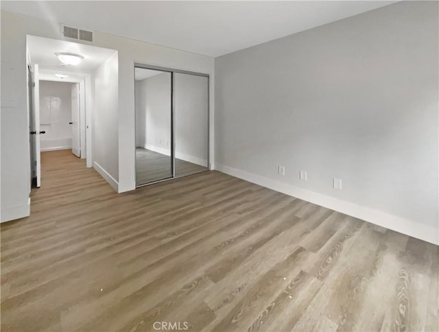 1564 Tanglewood Ln Unit 11, Escondido, CA 92029 - unfurnished bedroom featuring wood finished floors and a closet