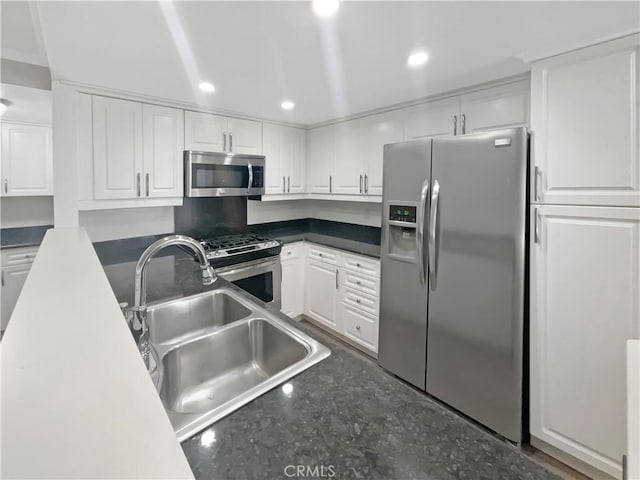 1564 Tanglewood Ln Unit 11, Escondido, CA 92029 - kitchen featuring stainless steel appliances, white cabinetry, recessed lighting, dark countertops, and concrete floors