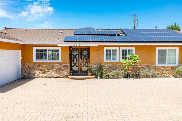 759 S Briargate Ln, Covina, CA 91723 - view of front of house featuring stone siding, stucco siding, solar panels, and french doors