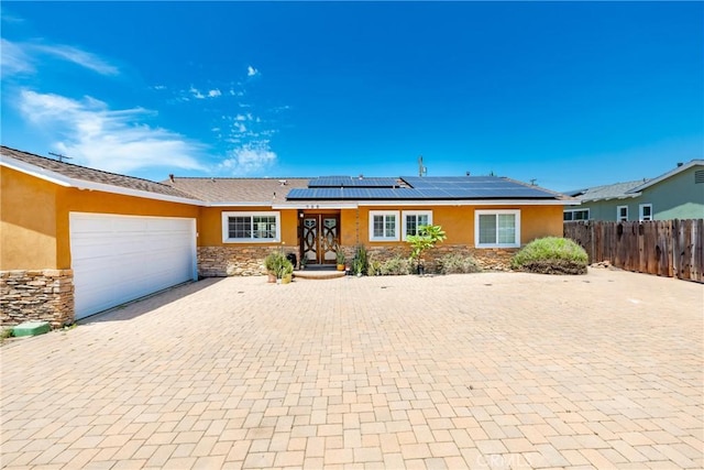 759 S Briargate Ln, Covina, CA 91723 - ranch-style home with stucco siding, stone siding, decorative driveway, a garage, and solar panels