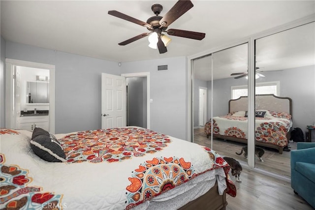759 S Briargate Ln, Covina, CA 91723 - bedroom with wood finished floors, two closets, a ceiling fan, and ensuite bathroom