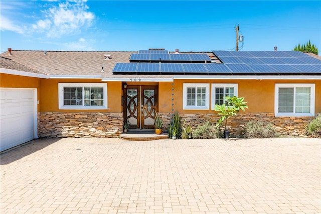 759 S Briargate Ln, Covina, CA 91723 - view of front of property with stone siding, stucco siding, roof mounted solar panels, and french doors