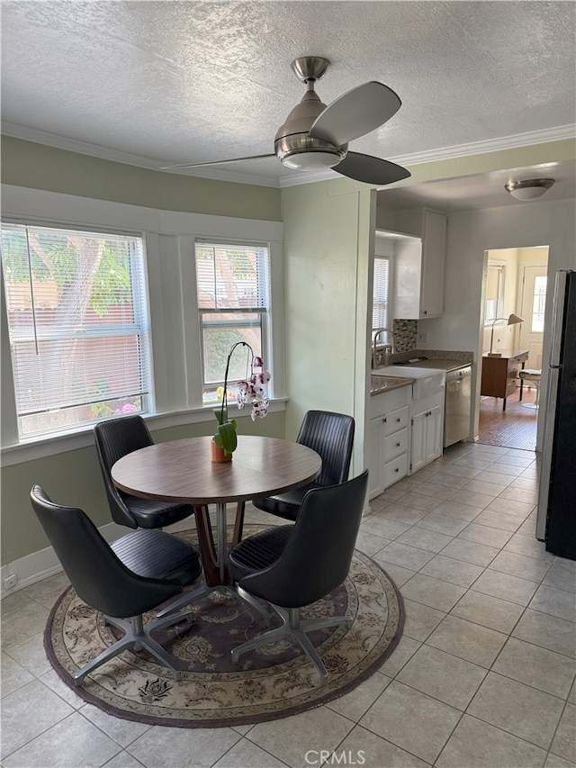 3031 S Denison Ave, San Pedro, CA 90731 - dining area featuring light tile patterned floors, a textured ceiling, ornamental molding, and ceiling fan