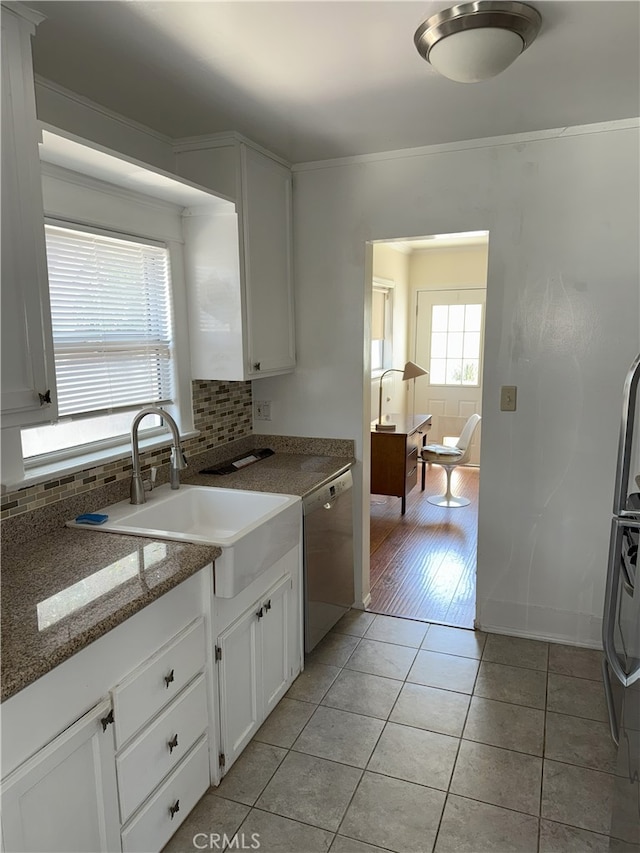 3031 S Denison Ave, San Pedro, CA 90731 - kitchen featuring dishwasher, light tile patterned floors, tasteful backsplash, white cabinetry, and stone countertops