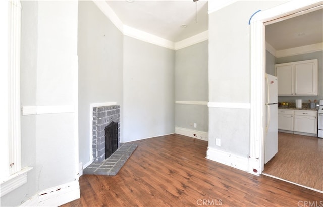340 E Main St, San Jacinto, CA 92583 - unfurnished living room featuring wood finished floors and a brick fireplace