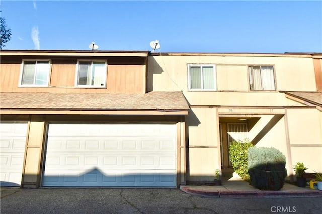 12828 Ramona Blvd Unit 96, Baldwin Park, CA 91706 - view of property with a garage and roof with shingles