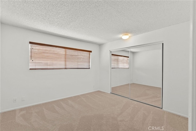 18555 Collins St Unit C30, Tarzana, CA 91356 - unfurnished bedroom featuring carpet flooring, a closet, and a textured ceiling