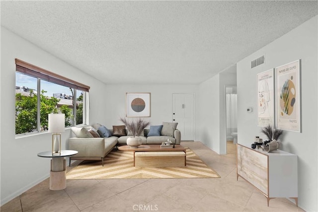 18555 Collins St Unit C30, Tarzana, CA 91356 - living area with a textured ceiling and light tile patterned floors