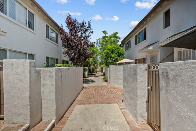 18555 Collins St Unit C30, Tarzana, CA 91356 - view of side of home with a gate and stucco siding