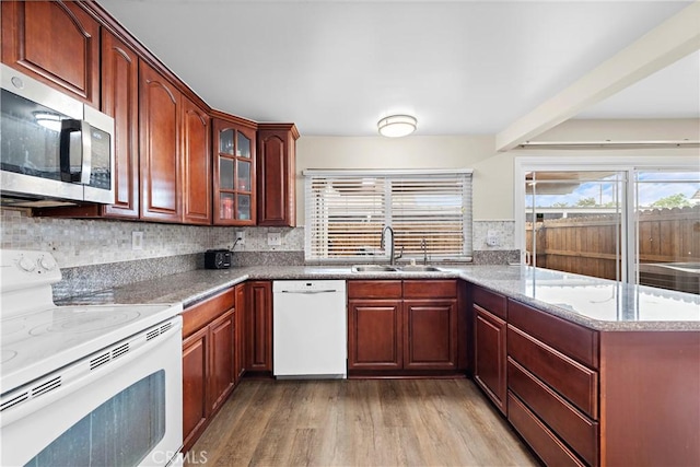 4690 Larwin Ave, Cypress, CA 90630 - kitchen with white appliances, light wood-style floors, plenty of natural light, and a peninsula