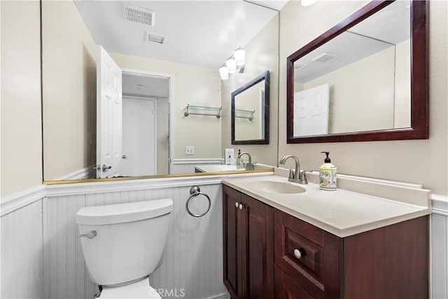 4690 Larwin Ave, Cypress, CA 90630 - bathroom with wainscoting, vanity, and a decorative wall