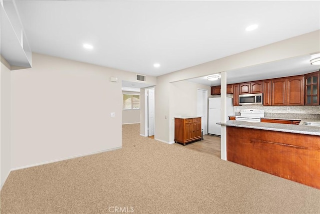 4690 Larwin Ave, Cypress, CA 90630 - kitchen featuring white appliances, light colored carpet, light countertops, glass insert cabinets, and brown cabinetry