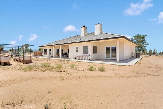 6643 Avenal St, Phelan, CA 92371 - back of property featuring a patio area, a chimney, french doors, and stucco siding