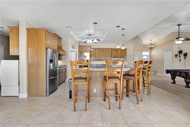 6643 Avenal St, Phelan, CA 92371 - kitchen with stainless steel fridge, a ceiling fan, refrigerator, light tile patterned floors, and vaulted ceiling