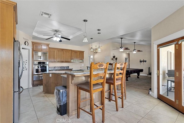 6643 Avenal St, Phelan, CA 92371 - kitchen featuring stainless steel appliances, a kitchen island, a ceiling fan, and light tile patterned flooring