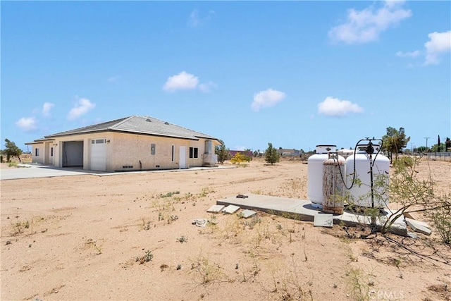 6643 Avenal St, Phelan, CA 92371 - view of yard with a garage and concrete driveway