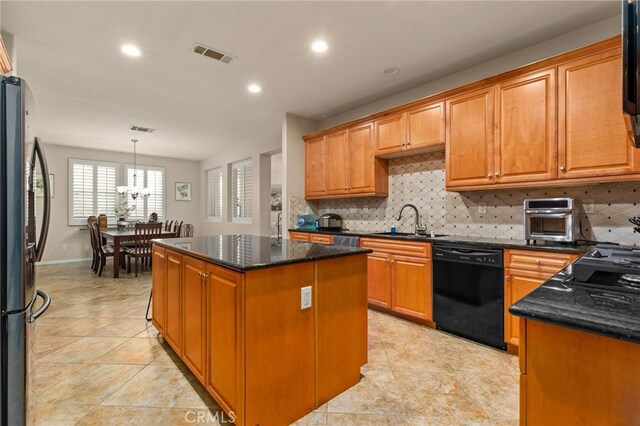 30355 Lamplighter Ln, Menifee, CA 92584 - kitchen with dishwasher, freestanding refrigerator, decorative backsplash, a kitchen island, and recessed lighting
