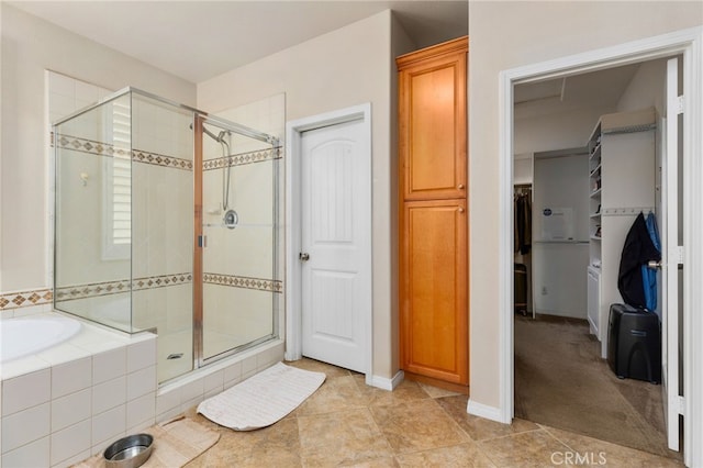 30355 Lamplighter Ln, Menifee, CA 92584 - bathroom featuring a shower stall, a garden tub, a spacious closet, and tile patterned flooring