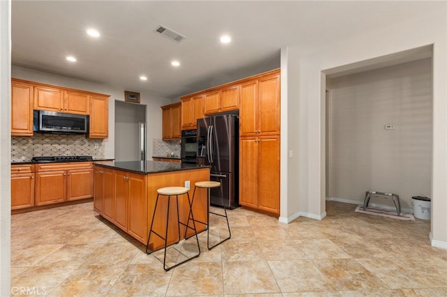 30355 Lamplighter Ln, Menifee, CA 92584 - kitchen with black appliances, a kitchen island, backsplash, recessed lighting, and brown cabinets