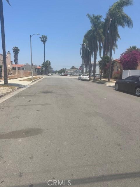 8463 S Halldale Ave, Los Angeles, CA 90047 - view of asphalt road with sidewalks, curbs, and street lighting