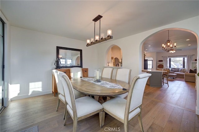 1910 Fixlini St, San Luis Obispo, CA 93401 - dining area with a chandelier, arched walkways, light wood-style flooring, and recessed lighting