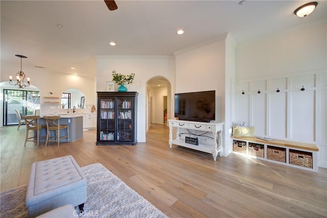 1910 Fixlini St, San Luis Obispo, CA 93401 - living area with arched walkways, a chandelier, crown molding, light wood finished floors, and recessed lighting