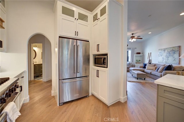 1910 Fixlini St, San Luis Obispo, CA 93401 - kitchen with high end appliances, a ceiling fan, arched walkways, light wood finished floors, and light stone counters