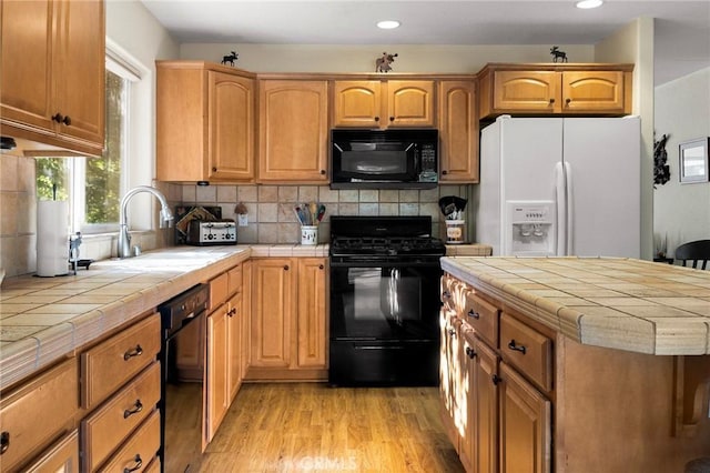 438 Watson Rd, Chester, CA 96020 - kitchen with black appliances, tile countertops, light wood-style floors, decorative backsplash, and recessed lighting